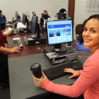 Team leader Joy Atkinson (left) and barista Cara Hutton try out the terminals at the Common Room...