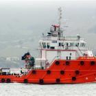 Tender supply vessel Jaya Amazon dwarfs tourist boat Monarch on Otago Harbour yesterday, ahead of...