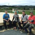 Terry and Jodie Owen (left), Roger Owen, and Derek Craig (right) test out the floor of the house...