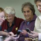 Texting tutor Aimee Dodds with Noeleen Thomas (79), Margaret Simpson (76) and Juliet O'Donell (66...