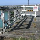 The 1884-vintage  Sumpter Wharf at Oamaru Harbour, closed to the public because of its dangerous...