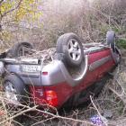 The crashed four-wheel-drive vehicle where it came to rest above the Kawarau River yesterday...