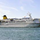 The cruise ship Spirit of Adventure, accompanied by tug Otago, heading up the channel toward Port...