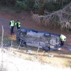 The driver of this car escaped uninjured after his car slid down a 25m bank and landed on its...