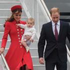 The Duke and Duchess of Cambridge, with Prince George, disembarking from the RNZAF jet after...