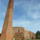 The Hoffmann kiln chimney towers above the ground at the McSkimmings pottery factory in Benhar,...