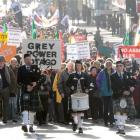 The "Keep Our Assets" protest moves along George St, Dunedin, on Saturday. Photo by Craig Baxter.