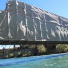 The Luggate Red Bridge over the Clutha River is set to lose its shroud  as repainting finishes....