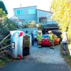 The Mitsubishi hatchback used for a driving lesson on Sunday rests on its side in a Dunedin...