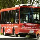 The new city loop bus resplendent in red with the route's stops marked along the side. Photo by...
