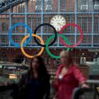 The Olympic Rings are seen as commuters walk in St Pancras Station, home of the Eurostar, in...