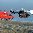 The Otago Regional Rescue Helicopter, flanked by similar Kawasaki BK117 craft,  flies in...