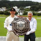 The Plunket Shield is carefully held by Wellington cricket captain Matthew Bell (left) and former...