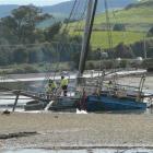 Volunteers from the Owaka Fire Brigade pump water from the scow during low tide last Friday....