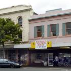 The protected building at 386 Princes St (behind tree), in Dunedin, has been declared unsafe by...