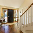 The recycled front door of Fred Black and Trish O’Neill’s Cromwell house leads into a spacious...