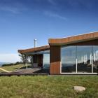 The repeating roof profile frames the end of the house. Photos by Simon Devitt.