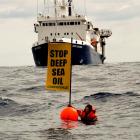 The seismic survey vessel <i>Orient Explorer</i> bears down on Greenpeace protester Kylee Mathews...