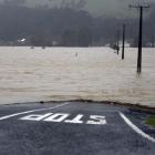 The Taieri river floods farm land after torrential rain closing SH1 south of Milton between...