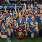 The Taieri team and staff celebrate with the Speight's Championship Trophy after winning the...