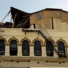 The top of the facade of the damaged building at 175 Rattray St is boarded up after the top...