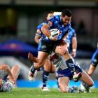 The Warriors' Konrad Hurrell breaks through the Raiders defence. Photo Getty