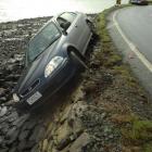 The woman driving this car was rescued by another driver after it slid off Portobello Rd during a...