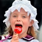 Thea Davis (8) of Dunedin enjoys a  toffee apple at the Victorian Fete in Oamaru yesterday. Photo...