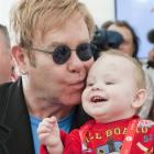 This is a September 12, 2009 AP file photo of singer Elton John as he kisses baby Lev during a...