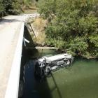 This van which carried a  family group of 10 lies in the Mataura River after crashing off Nokomai...