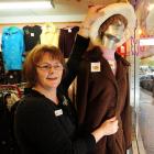 Thrift store manager Robyn Elliman tidies up the storefront mannequin which was the subject of a...