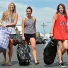 Throwing trash away from their Castle St flat in Dunedin yesterday were (from left) Olivia van...