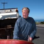 Tidy Bins owner Michael Miller rolls another drum out to his truck. After 15 years of handling...