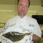 Tim Lynch and his freshly caught and cooked flounder. Photo by Pene Spencer.