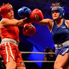Tina Stevens (right) delivers one of her winning punches  to Anna Esquilant in the Southern...