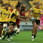 TJ Perenara of the Hurricanes looks to pass during the round four Super Rugby match between the...