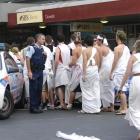 Police speak to students during February's toga parade, which descended into disorder, leaving...