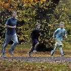 Tom, Finn (centre) and Hamish McKinlay run through Chingford Park.