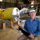 Tom Grant with his Albatros and SE 5a replica World War 1 aircraft. Mr Grant holds a piece of the...