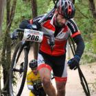 Tom Kaminszky and Dave Hedley (background) carry their bikes up an unrideable stretch of the...