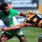 Tomasi Cama of Manawatu fends off Kane Barrett of Taranaki during their ITM Cup match at Yarrow...