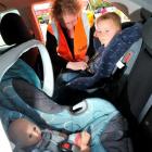 Tonia Scoullar, Otago-Southland Plunket car seat co-ordinator, shows the correct way to put Van...