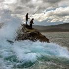 Tony George (left) and Tobias Downie, both from Temuka, fish from a rocky ledge. Photos by...