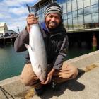 Top: Poeun Sem (36) shows off the 5.5kg salmon he caught from Harbour Basin, Dunedin, yesterday...