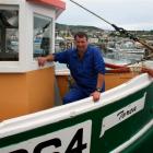 Torea skipper Peter Leask on the boat at Bluff after it was repaired and upgraded last year....