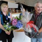 Tourist Peter Hunt is presented with flowers and a gift basket by Toitu Otago Settlers Museum...