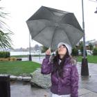 Tourist Sienna Chin, of Taiwan, shelters under her umbrella at Lake Wanaka. Photo by Matthew...