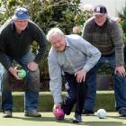 Tournament boss Neill Williams is supported by brothers Jim and Terry Scott as he tests the green...