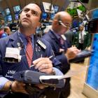 Trader Joseph Acquafredda, left, check the numbers near the close of trading on the floor of the...