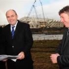 Transport Minister Steven Joyce (centre) checks the site of a planned roundabout, to be built as...